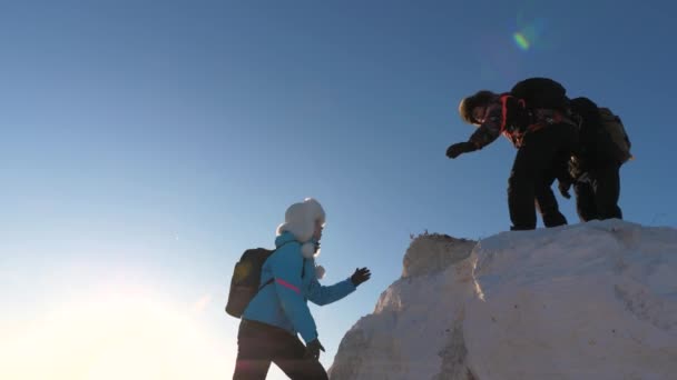 Travelers climb one after another on the rock. Teamwork of business people. Climbers silhouettes stretch their hands to each other, climbing to the top of hill. A team of businessmen is going to win. — Stock Video