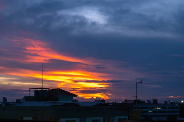 stock image Watching the sunset over the city, with a roof