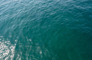 The azure waters reflected the sun's rays, sting the eyes, and were so deep that they couldn't even see the bottom.