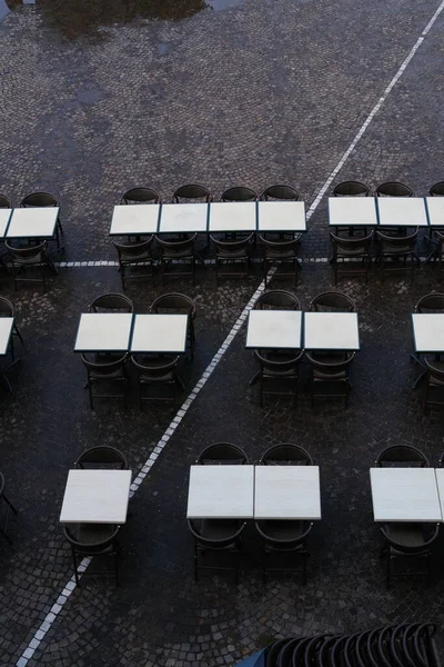 Urban composition of a square with tables and chairs