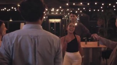 Bir grup arkadaş çatı katında ve restoranda eğleniyor.