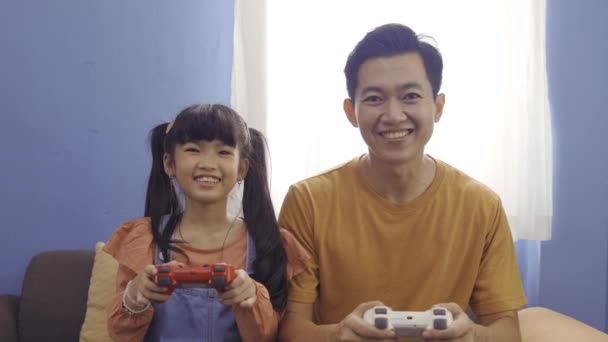 Cheerful father and daughter playing videogame together — Stock Video