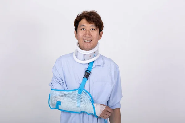 Portrait Smiling Handsome Asian Man Broken Arm Neck Isolated White — Zdjęcie stockowe