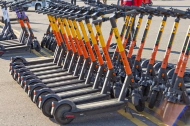 Elektrikli scooterlar kirada kürek çekmek için park edilmiş. Rusya, Soçi, 04 Aralık 2021