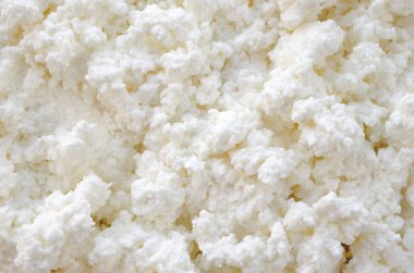 Arka plan olarak süt kaymağı, yakın plan, üst görünüm. Taze süzme peynir, arka plan, doku, üst manzara. Taze süt, yakın plan, üst manzara. Süt ürünleri - taze kaymak.