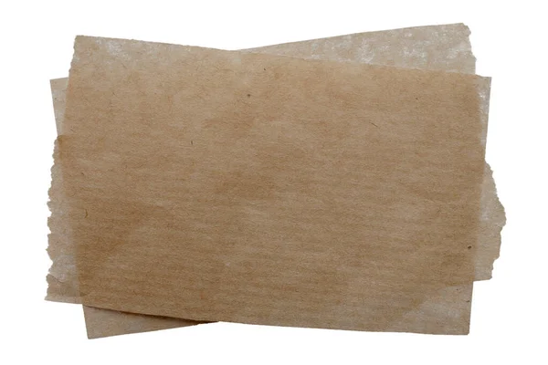 Folhas castanhas de papel manteiga isoladas sobre fundo branco, vista superior. Papel kraft para assar isolado no fundo branco, vista superior. Papel para assar em um fundo branco. Imagem De Stock