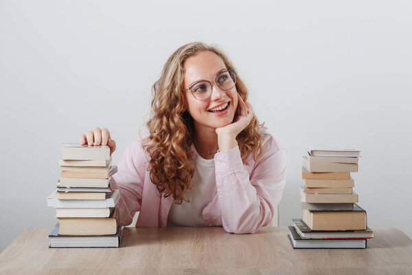 girl dreams of hugging a stack of books