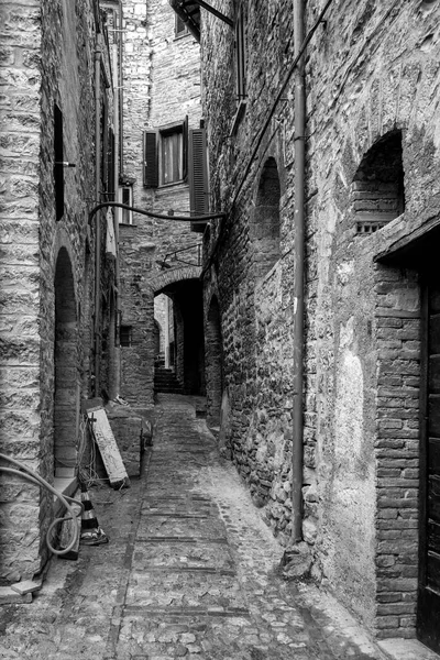 Black and white view of an old alley in the village of Spello (Umbria Region, Central Italy), a medieval village, famous for a flower country fair, named Infiorata (held yearly, between May and June).