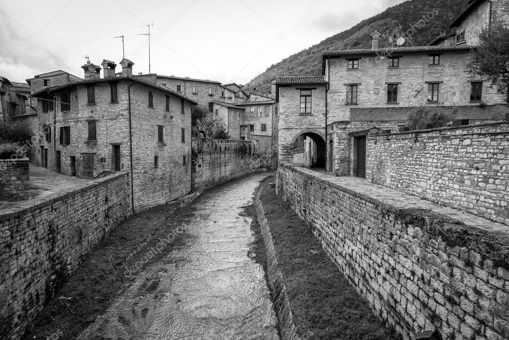 Black and white view of an old alley in the village of Spello (Umbria Region, Central Italy), a medieval village, famous for a flower country fair, named Infiorata (held yearly, between May and June).