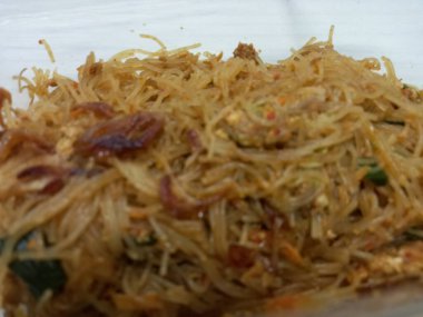 Vermicelli fried or called bihun goreng served in a plastic box with top view photo