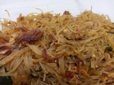 Vermicelli fried or called bihun goreng served in a plastic box with top view photo