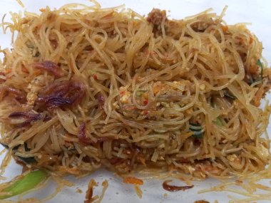 Vermicelli fried or called bihun goreng served in a plastic box with top view photo