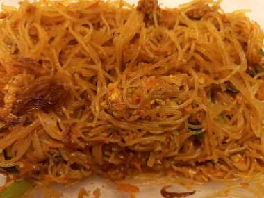 Vermicelli fried or called bihun goreng served in a plastic box with top view photo