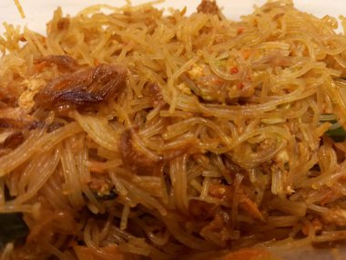 Vermicelli fried or called bihun goreng served in a plastic box with top view photo