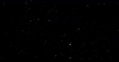 Parıldayan uçan parçacıklarla soyut bir arkaplan. Parlayan parçacıklarla 4K video animasyonu. Beyaz noktalar hareket ediyor ve karanlık uzayda yanıp sönüyor