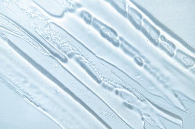 Gel texture background in cold blue colors. Banner for moisturizing cosmetic presentation. Antiseptic wallpaper. Hydration medical. Liquid gel cosmetic smudge. Transparent cosmetic sample