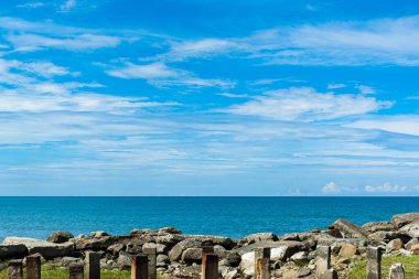 Blue sea under blue skies with white clouds at Tanjung Aru Beach, Kota Kinabalu, Sabah, Malaysia.