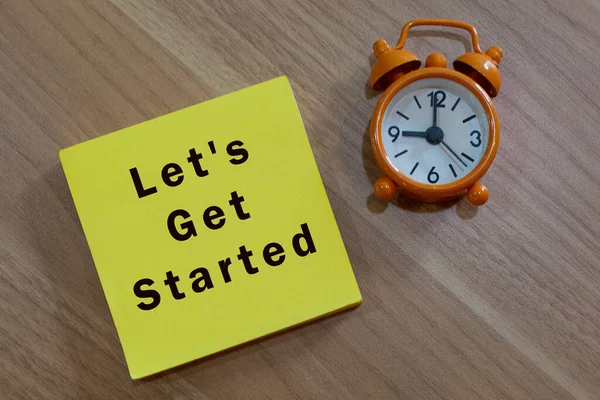 Lets Get Started Message Advice Yellow Notepad Alarm Clock Wooden — Stock Photo, Image