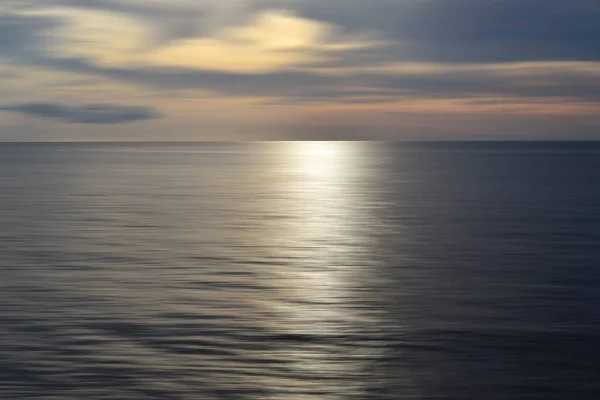 Sfocato oceano paesaggio sfondo e vista al tramonto in effetto movimento digitale. — Foto Stock