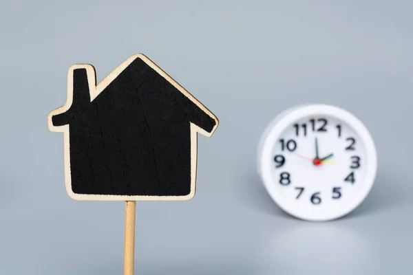 Wooden House Model Blurred White Alarm Clock Background Real Estate — Stock Photo, Image