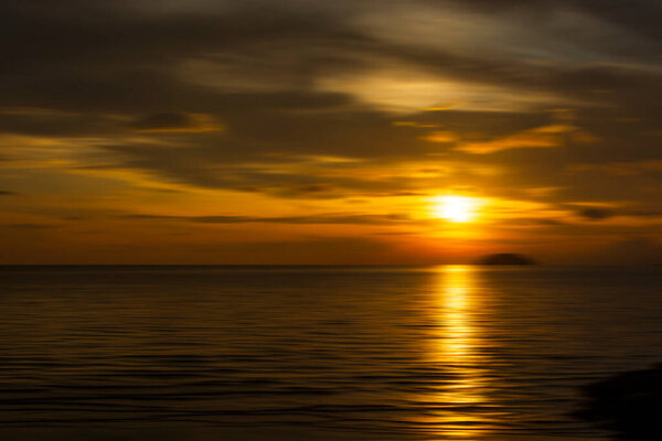 Sunset background at the beach of Tanjung Aru, Sabah, Malaysia with motion blur.