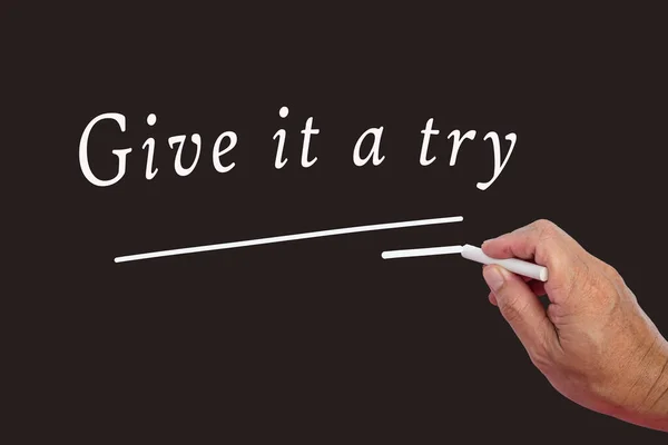 Male Hand Writes White Chalk Pencil Word Give Try Black — Stockfoto