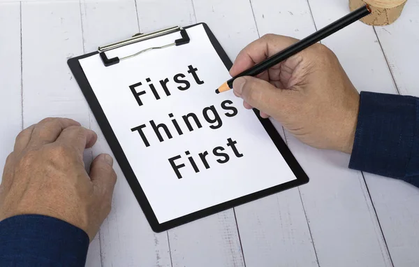 Hand Pencil Writing Words First Things First Paper Black Clipboard — Foto de Stock