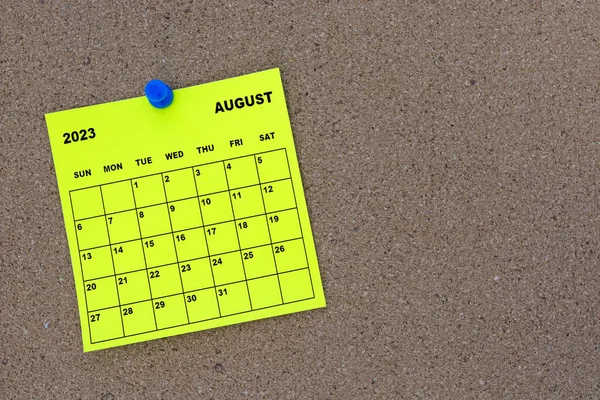 August 2023 Yellow Sticky Note Calendar Pin Cork Bulletin Billboard — стоковое фото