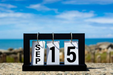 Sep 15 calendar date text on wooden frame with blurred background of ocean. Calendar date concept.