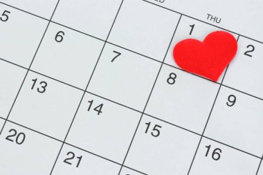 Red heart shape on the date of the 1st day in the calendar. Important calendar date to remember.
