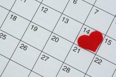 Red heart shape on the date of the 14th day in the calendar. Important calendar date to remember.