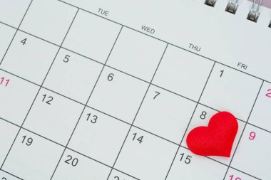 Red heart shape on the date of the 8th day in the calendar. Important calendar date to remember.
