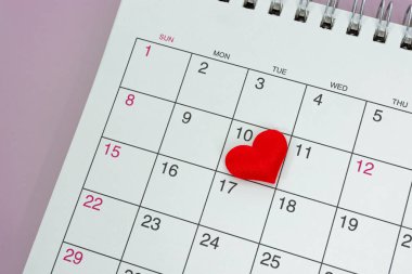 Red heart shape on the date of the 10th day in the calendar. Important calendar date to remember.