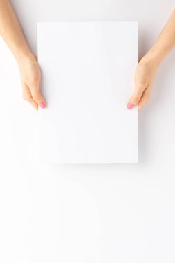 Kadın eli boş beyaz kağıt çarşaf tutuyor. Model