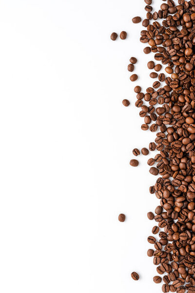 Roasted coffee beans isolated on white background. Close up