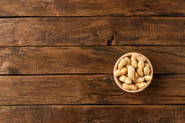 Tasty Peanuts Bowl Wooden Background Copyspace Top View — Stock Photo, Image