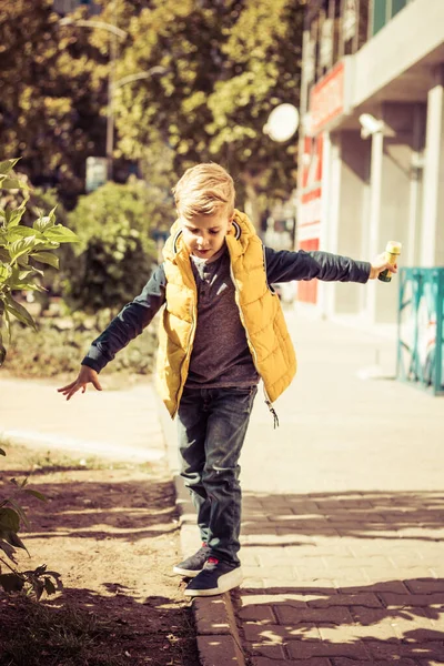 Little Boy Arms Outstretched Walking Sidewalk City — Zdjęcie stockowe
