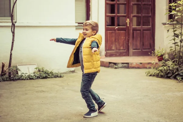 Carefree Kid Having Fun While Spinning Arms Outstretched Outdoors — Fotografia de Stock