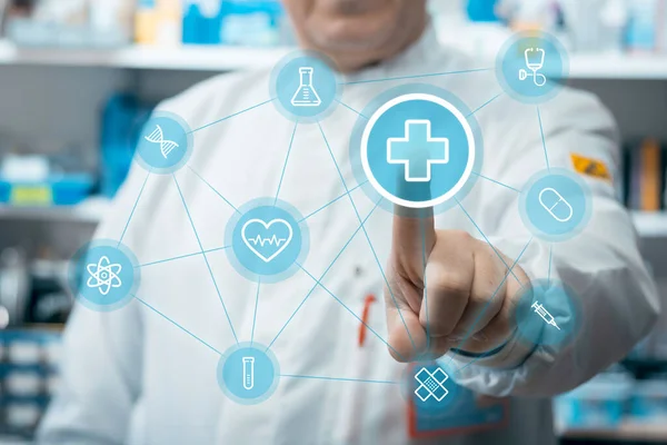 Male doctor using healthcare application on touch screen in medical laboratory. 