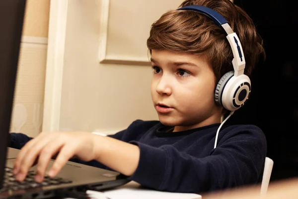 Small Boy Wearing Headphones Using Computer While Playing Video Games — Foto de Stock