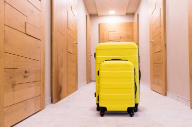 Yellow suitcases in a hallway. Travel bags.