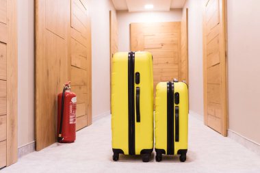 Travel bags in a lobby. Yellow suitcases.