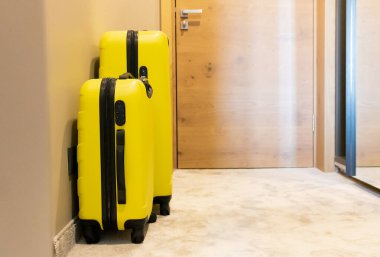 Yellow suitcases in hotel room.
