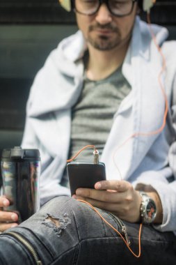 Close up of man using smart phone during his coffee time.