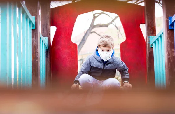 Small Kid Wearing Protective Face Mask Playground Due Coronavirus Pandemic — Stockfoto
