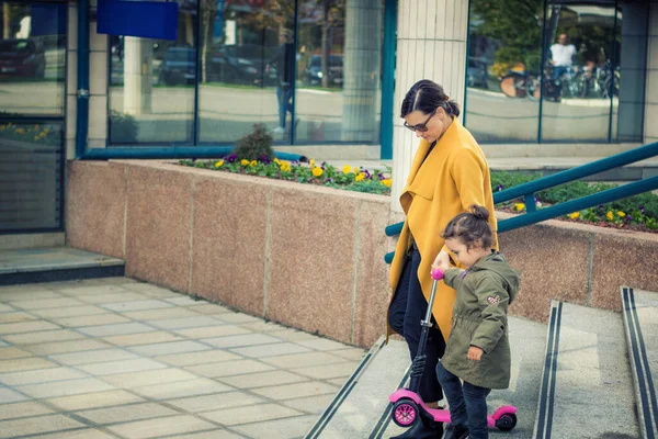 Young Mother Assisting Her Small Daughter While Walking Stairs City — ストック写真