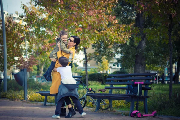 Joyful Kids Embracing Mother While Meeting Her Park — Stok fotoğraf