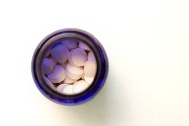 Medicines in pill bottle. Prescription drugs in blue bottle. 