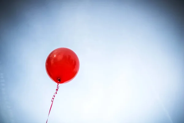 Red balloon against the sky.