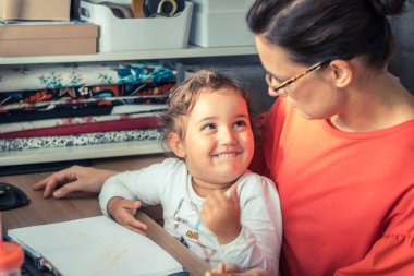 Smiling daughter communicating with her mother and enjoying in time together at home. 